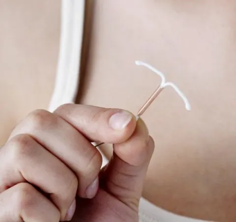Hand holding IUD